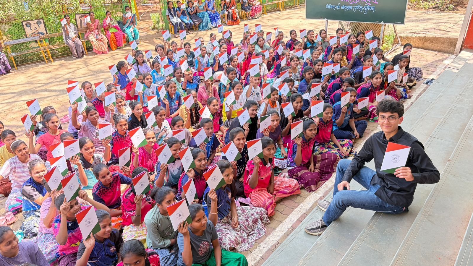 Students in Palghar holding the Workers of India booklet